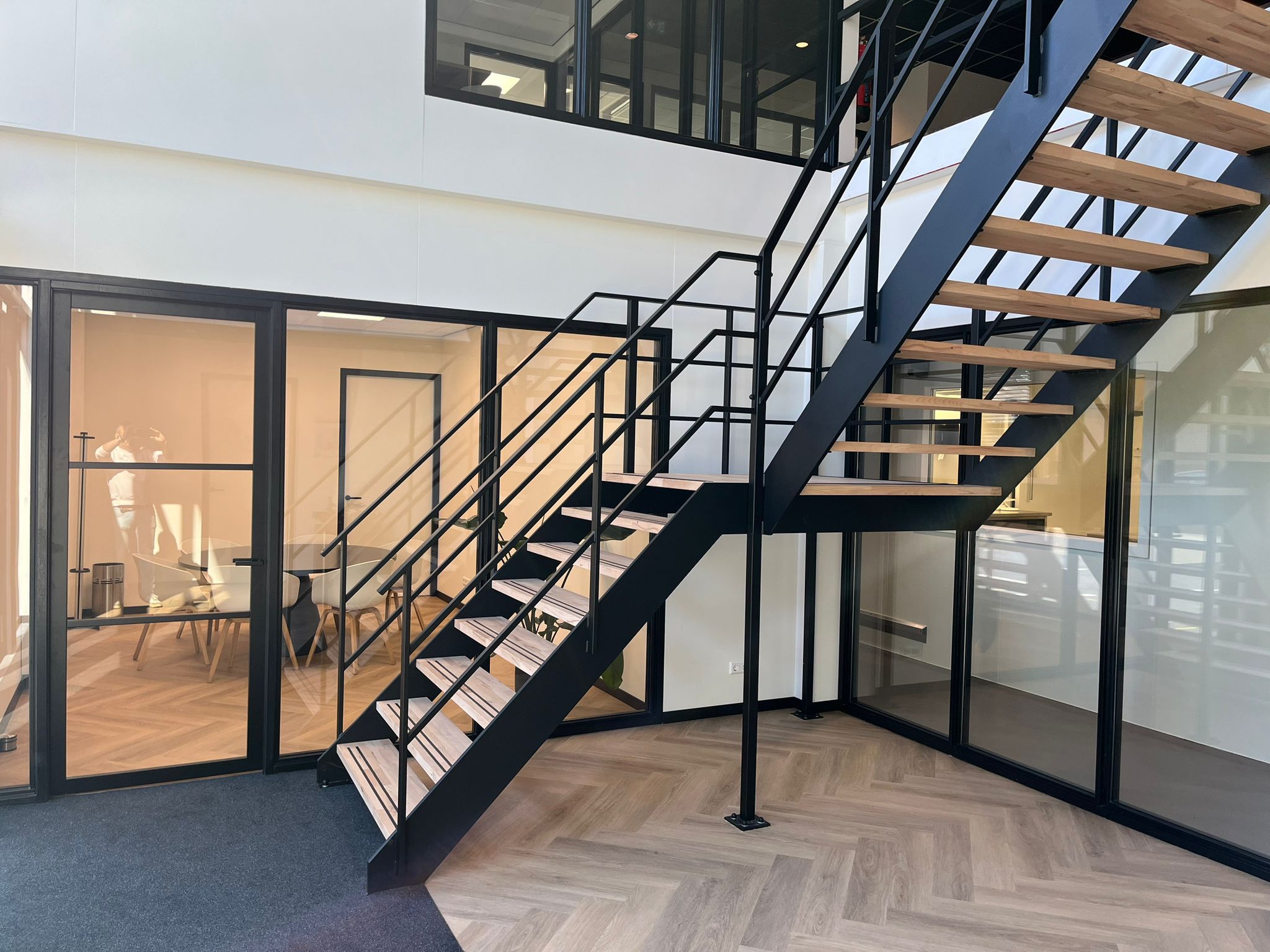 Zwarte stalen interieurtrap met houten treden, ontwerp en engineering door Previn Engineering